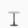 Round dining table with marble top and metal pedestal base.