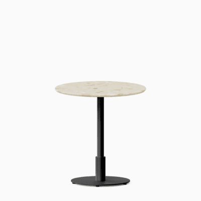 Round dining table with terrazzo top and metal pedestal base.