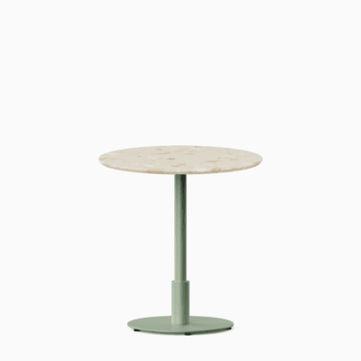Round dining table with terrazzo top and metal pedestal base.
