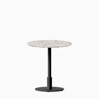 Round dining table with terrazzo top and metal pedestal base.