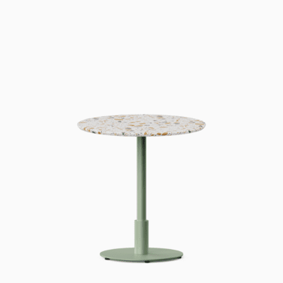 Round dining table with terrazzo top and metal pedestal base.