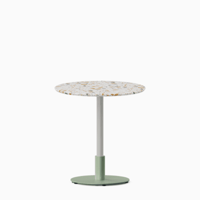 Round dining table with terrazzo top and metal pedestal base.