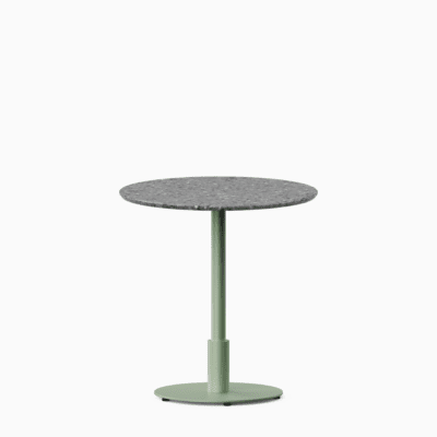 Round dining table with terrazzo top and metal pedestal base.