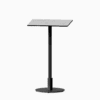 Square bar table with compact‑laminate top and metal pedestal base.