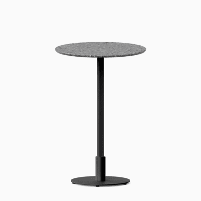 Round bar table with terrazzo top and metal pedestal base.