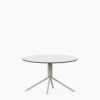 Round compact‑laminate coffee table with aluminium base.