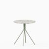 Round terrazzo table with speckled stone top and powdercoated aluminium base.