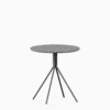 Round terrazzo table with speckled stone top and powdercoated aluminium base.
